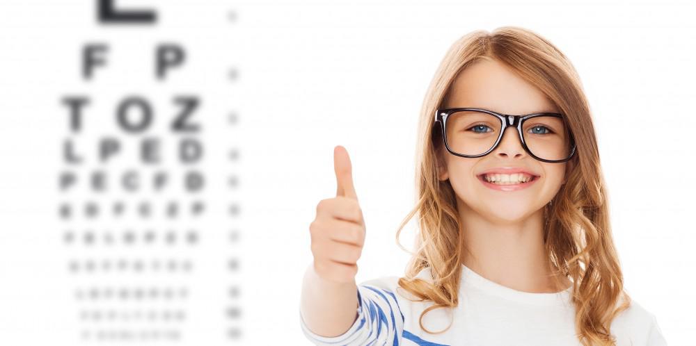 Child wearing glasses giving the thumbs up