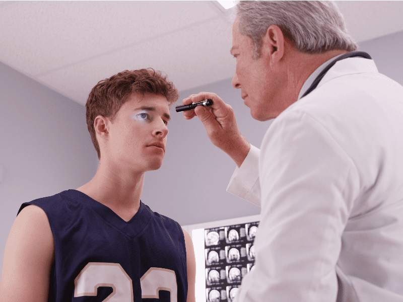 Young man having his eyes examined
