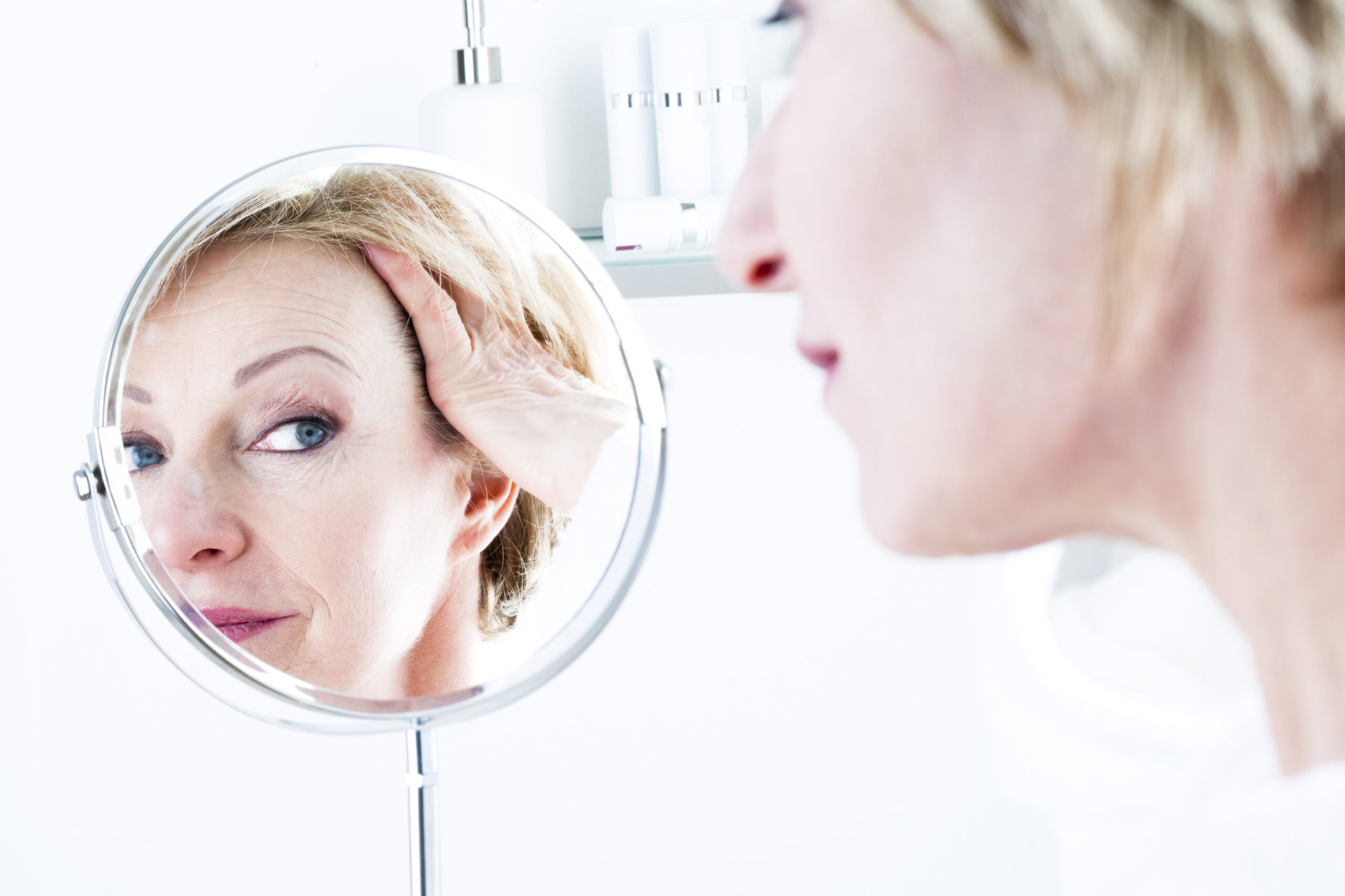 woman looking in mirror